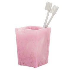 two toothbrushes sticking out of a pink tissue paper holder on a white background