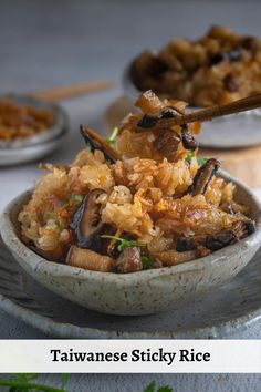 a bowl filled with rice and mushrooms on top of a table