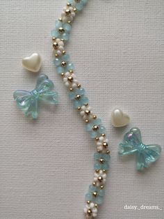 the beaded necklace is decorated with hearts and bows