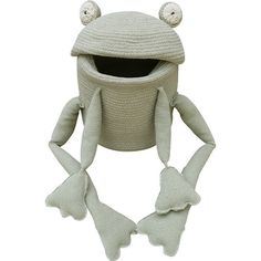 a knitted frog hat and mitten set with ears, eyes and tail sitting on top of a white surface