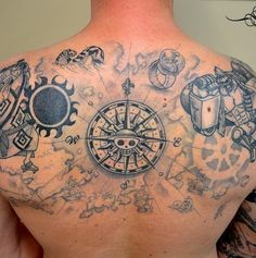 the back of a man with tattoos on his chest