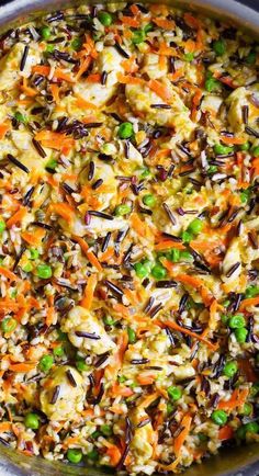 a pot filled with rice and vegetables on top of a stove