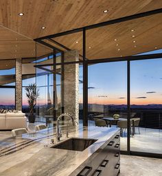 the kitchen is very large and has glass walls to look out onto the mountains outside