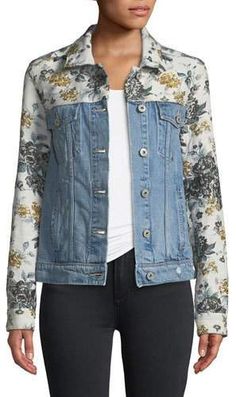 a woman wearing a jean jacket with flowers on it