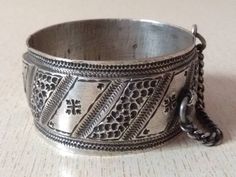 A superb old Berber silver bracelet from Morocco. The surface of the bangle has been finely hand-etched with a design combining lines, and the surface as well as interior have both obtained a very rich patina from wear and usage. It opens and closes with a pin. Inner diameter : 6,3 cm (2,48 inches) Width : 3,4 cm (1,3 inches) Weight : 116 g Ornate Stamped Bracelets For Gift, Engraved Antique Silver Bangle, Traditional Engraved Sterling Silver Bracelet For Formal Occasions, Traditional Engraved Bracelets, Traditional Engraved Collectible Bracelets, Ornate Stamped Bangle Bracelet, Traditional Silver Stamped Bracelets, Traditional Silver Stamped Bracelet, Traditional Stamped Bracelets