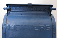 an old blue metal box with the word letters written on it's front side