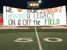 a sign on the sidelines at a football game that reads we our seniors leaving a leaguey on & off the field