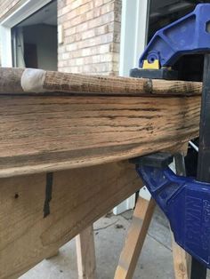 a close up of a wooden boat being worked on by a woodworker in the process