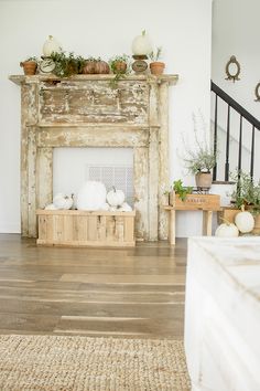 a living room filled with furniture and a fire place in front of a wooden mantel