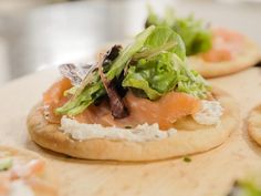 small crackers with different types of food on them