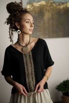 Women's blouse made of linen crepe in black The blouse has a simple loose form, on the front it has a sewn application of jute lace We sew it in sizes S M L The model in the picture is 171 cm tall and wears size M Dimensions of the blouse flat: bust S/122 cm M/126 cm L/130 cm bottom width S/104 cm M/108 cm L/112 cm blouse length S,M/ 55 cm L/60 cm Material: linen 100% Remark! Hand wash recommended Black Tunic Blouse For Beach, Boho Tops Summer, Black Top Summer, Long Cotton Skirt, Black Blouse Women, Long Maxi Skirts, Womens Tops Summer, Summer Black, Linen Blouse