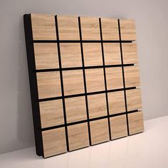 a wooden panel with black squares on it