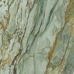 the marble is green and brown with gold streaks on it's edges, as well as some other colors