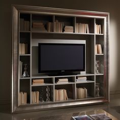 an entertainment center with bookshelves and a flat screen tv