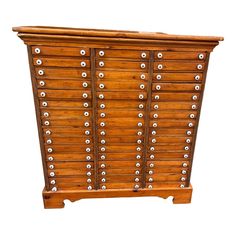 an old wooden cabinet with many drawers and knobs on the front, isolated against a white background