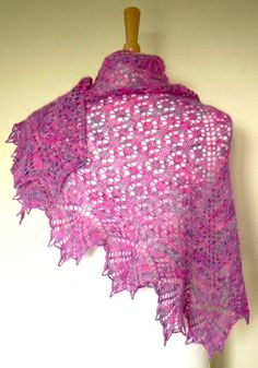 a pink shawl is hanging on a wall