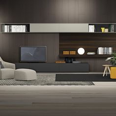 a living room filled with furniture and a flat screen tv sitting on top of a wooden wall