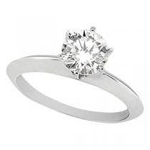 a white gold solute ring with a round diamond in the center, set on top of