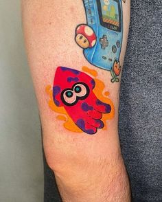 a person with a tattoo on their arm has an image of a cartoon character on it