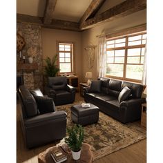 a living room filled with furniture and a fire place next to a stone wall mounted fireplace