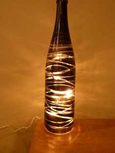 a bottle that is sitting on a table with some lights in the top and bottom