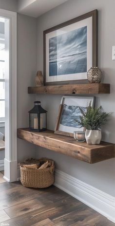 a wooden shelf with some pictures on it and a lantern in the corner next to it