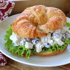 a croissant sandwich with chicken salad on it