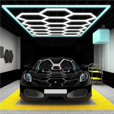 a black sports car is parked in a room with yellow and white flooring on the walls