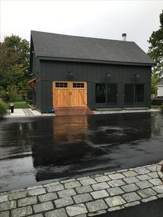 a garage with an open door on the front and side of it in the rain