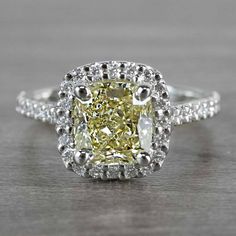 a fancy cushion cut yellow diamond ring