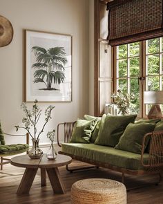 a living room filled with green furniture and pillows on top of wooden flooring next to a window