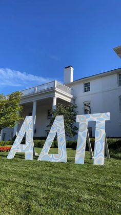 the letters are in front of a large white house