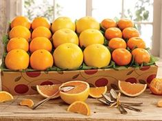 a box filled with lots of oranges on top of a table