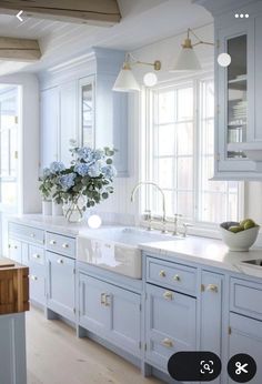 a white kitchen with blue cabinets and drawers