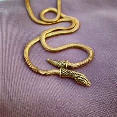 by Anomaly Jewelry Spiritual Snake-shaped Metal Jewelry, Spiritual Metal Jewelry In Snake Shape, Spiritual Brass Snake-shaped Jewelry, Engraved Metal Snake-shaped Jewelry, Spiritual Brass Jewelry In Snake Shape, Symbolic Snake-shaped Necklace For Gift, Symbolic Snake Shaped Necklace For Gift, Symbolic Snake Necklace As A Gift, Gold Snake-shaped Engraved Necklace