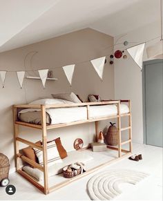 there is a bunk bed in the room with bunting flags on the wall above it