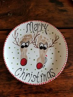 a christmas plate with two reindeers painted on it