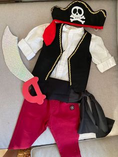 a pirate costume is laid out on a couch