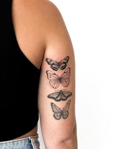 a woman's arm with three butterfly tattoos on her left arm and the other half of her arm