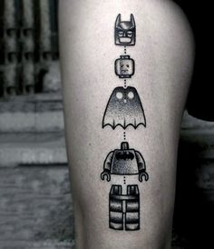 a black and white photo of a person's leg with legos on it