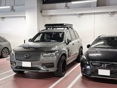 three cars parked in a parking garage with their lights on and no one around them