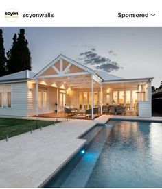 an image of a house with a pool in the front yard and lights on it