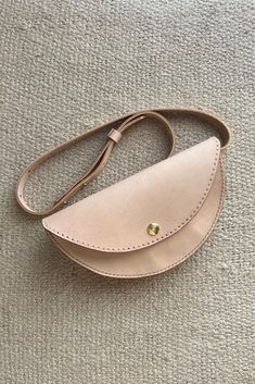 This locally made, 100% genuine leather belt bag is the perfect addition to any outfit. The natural leather will age beautifully over time and patina to a well-loved hue. Can be worn alone as a belt or with our leather belt bag for a more snug fit. Details: Strap length: 50.75" Cross body or around the waist Leather Belt Bag, Fit Details, Aging Beautifully, Genuine Leather Belt, The Natural, Natural Leather, Belt Bag, Leather Belt, Snug Fit