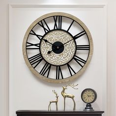 a clock that is on the side of a wall next to a deer figurine