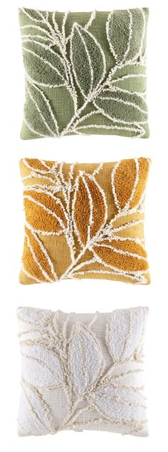 three decorative pillows in different colors