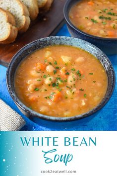 two bowls of white bean soup on a blue tablecloth with bread in the background