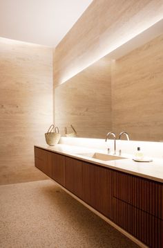 a bathroom with two sinks and a large mirror on the wall next to each other