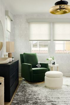 a living room with a green chair and ottoman