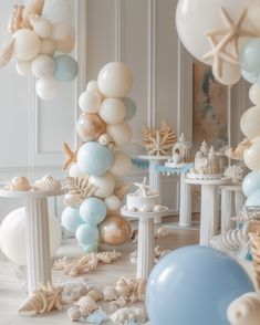 a room filled with balloons and seashells on the floor