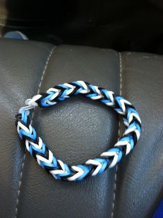 a blue and white braided bracelet sitting on top of a car seat